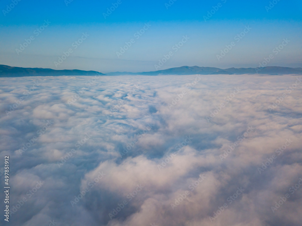 Flight over fog in Ukrainian Carpathians in summer. Mountains on the horizon. Aerial drone view. Flight over fog in Ukrainian Carpathians in summer. Mountains on the horizon. Aerial drone view.