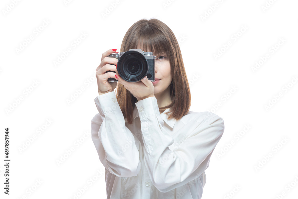 Portrait of a young woman in a white shirt taking pictures with a camera. The concept of a successful photographer, wedding photographer, photo for documents. Isolated on white background. Portrait of a young woman in a white shirt taking pictures with a camera. The concept of a successful photographer, wedding photographer, photo for documents. Isolated on white background.