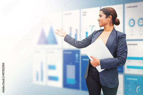 Energetic Indian woman presenting annual reports of the successful business company photo