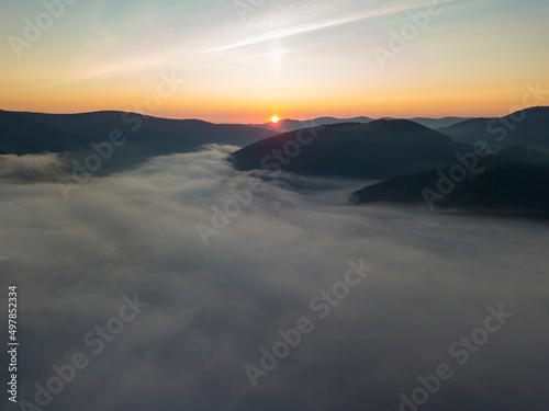 Sunrise over the fog in the Ukrainian Carpathians. Aerial drone view.