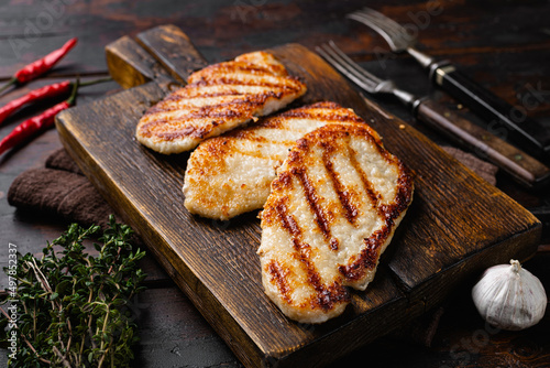 Pork  meat schnitzel, on old dark  wooden table background photo