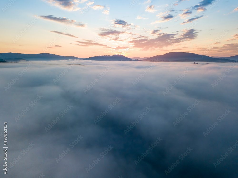 Sunrise over the fog in the Ukrainian Carpathians. Aerial drone view. Sunrise over the fog in the Ukrainian Carpathians. Aerial drone view.