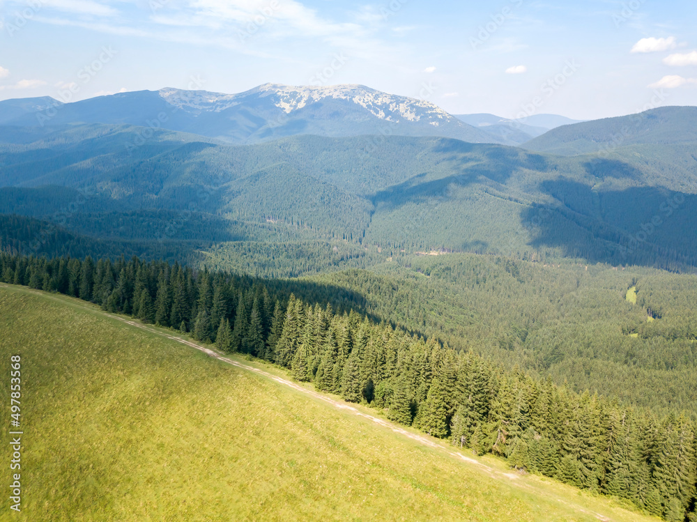 Green mountains of Ukrainian Carpathians in summer. Sunny day, rare clouds. Aerial drone view. Green mountains of Ukrainian Carpathians in summer. Sunny day, rare clouds. Aerial drone view.