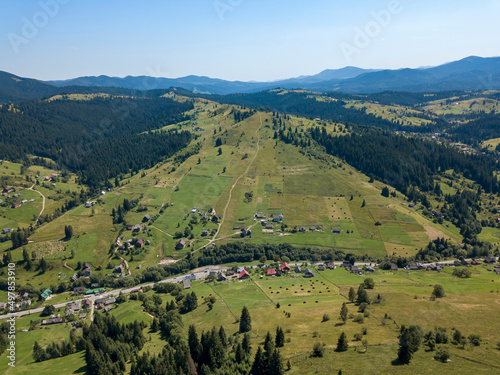 Green mountains of Ukrainian Carpathians in summer. Sunny clear day. Aerial drone view.