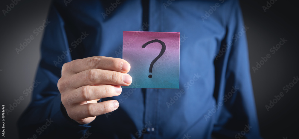 Man showing question mark on sticky note. Man showing question mark on sticky note.