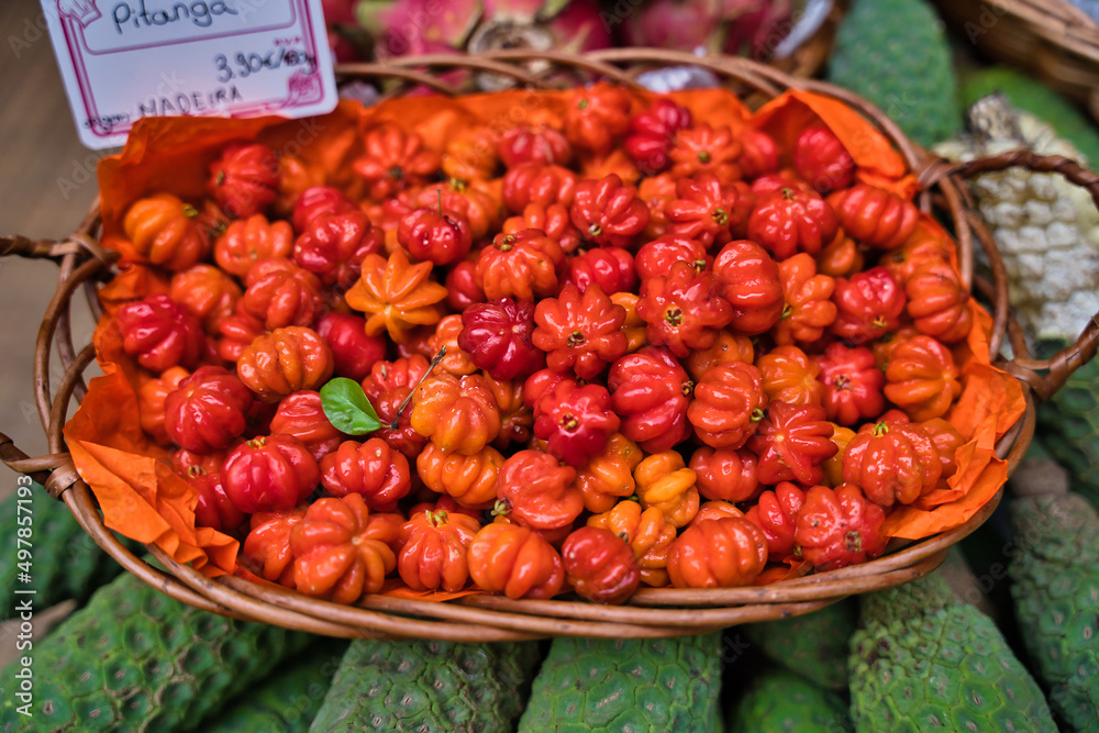 fresh pitanga fruits in wicker basket traditional and tropical Madeira market in Funchal, Portugal fresh pitanga fruits in wicker basket traditional and tropical Madeira market in Funchal, Portugal