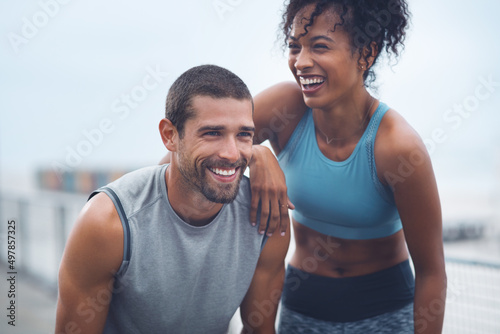 The journey were taking has been so rewarding. Shot of a sporty young couple taking a break while exercising outdoors. photo