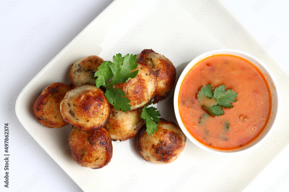 Kuzhi Paniyaram served with coconut chutney and sambar- South Indian breakfast Kuzhi Paniyaram served with coconut chutney and sambar- South Indian breakfast