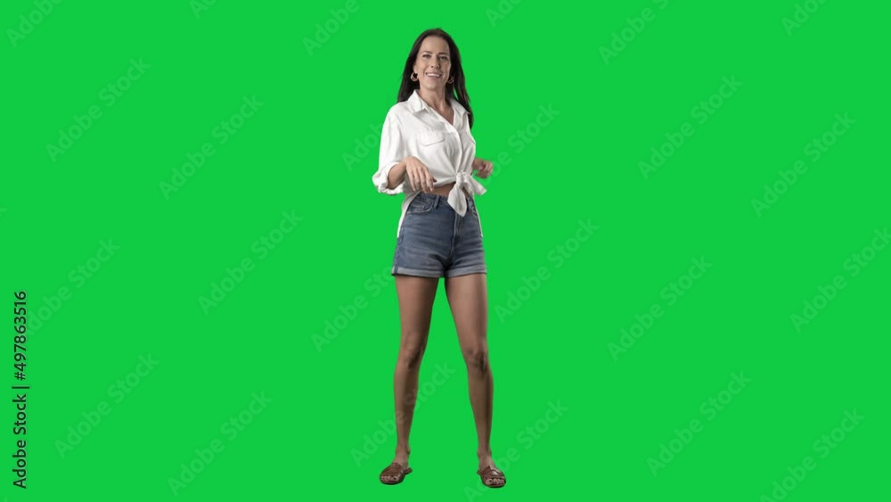 Carefree stylish summer girl singing and dancing to music. Full body isolated on green screen background Carefree stylish summer girl singing and dancing to music. Full body isolated on green screen background