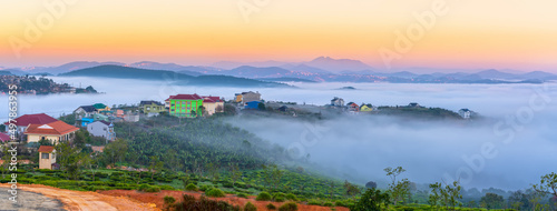 Morning landscape in a small town blurred in the morning mist with dawn sky background is peaceful in highlands Da Lat  Vietnam