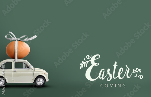 Retro car carrying an easter egg atop. Easter coming