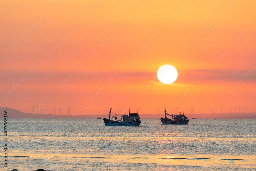 Sunset landscape when fishing boats out to sea to harvest fish end the day.