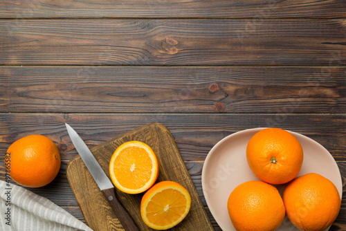 Fresh ripe oranges on cutting board on table. Top view Flat lay