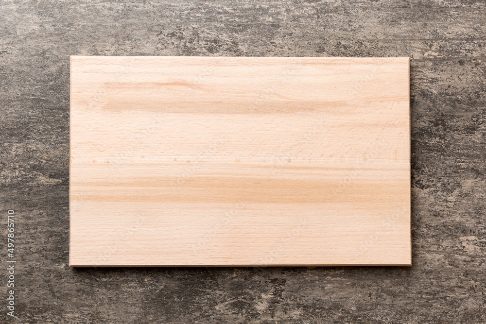 Top view of wooden cutting board on cement background. Empty space for your design Top view of wooden cutting board on cement background. Empty space for your design