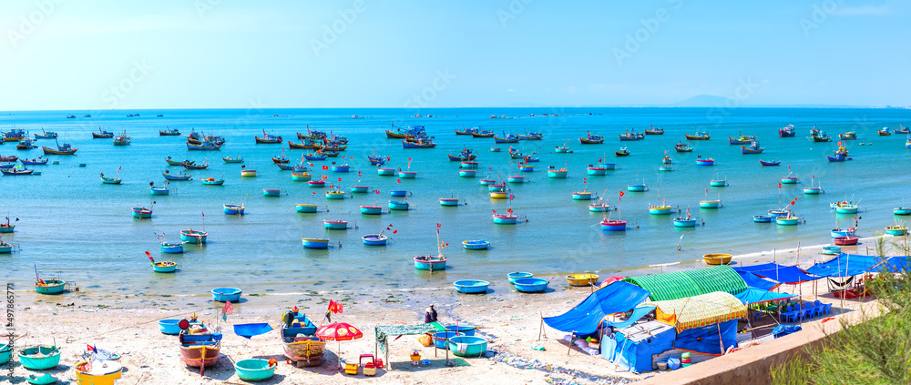 Fishing village and traditional fishing boat with hundreds boats anchored in sunny moring. This is bay for boats avoid rainy season storms in Mui Ne, Vietnam