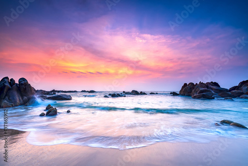 Beautiful beach on sunrise below the waves lapping at the shore of the soft great to welcome the peaceful new day