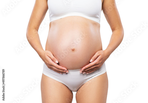 Wallpaper Mural Young pregnant woman in swimsuit. Girl expecting a baby and touching her belly isolated on white background. Close-up image. Torontodigital.ca