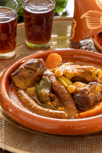 view of a royal couscous composed of chicken, lamb, merguez on a platter