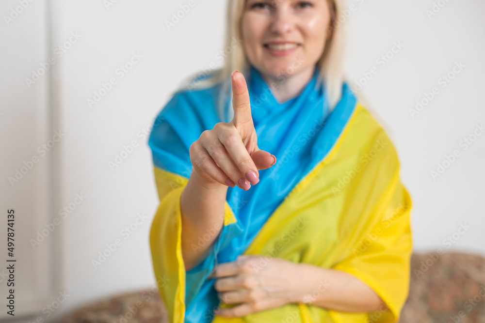 blonde woman wrapped in Ukraine flag. Support for Ukraine concept blonde woman wrapped in Ukraine flag. Support for Ukraine concept