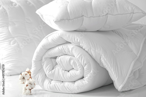 Two pillows and a folded blanket on a white background. Bedding items on a white background. Bedding catalog