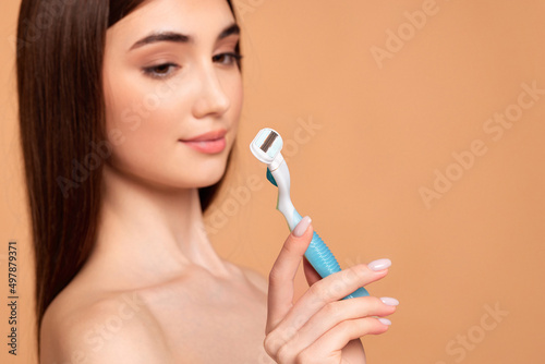 attractive girl holding in hand razor shaver blade i