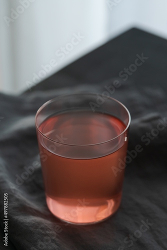 Berry lemonade in tumbler glass on linen cloth