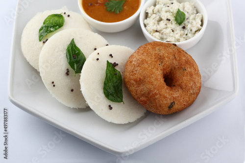 South Indian Breakfast menu, Idly Vadai with coconut chutney and sambar, served in a white Ceramic plate