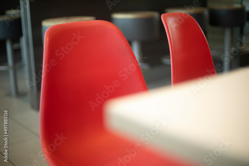 Red chairs made of plastic. Places in restaurant.