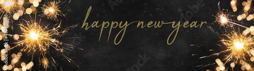 Silvester Party New year background banner panorama long, holiday greeting card - Sparklers and bokeh lights on dark night texture, with space for text