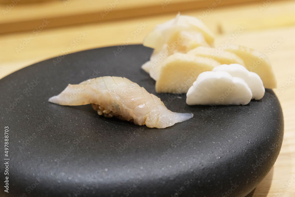 Fresh hirame flounder sushi nigiri at Japanese restaurant.