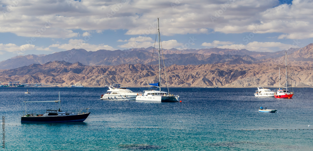 Pleasure and cruise tourist boats in the Red Sea, near coral reefs, Middle East

