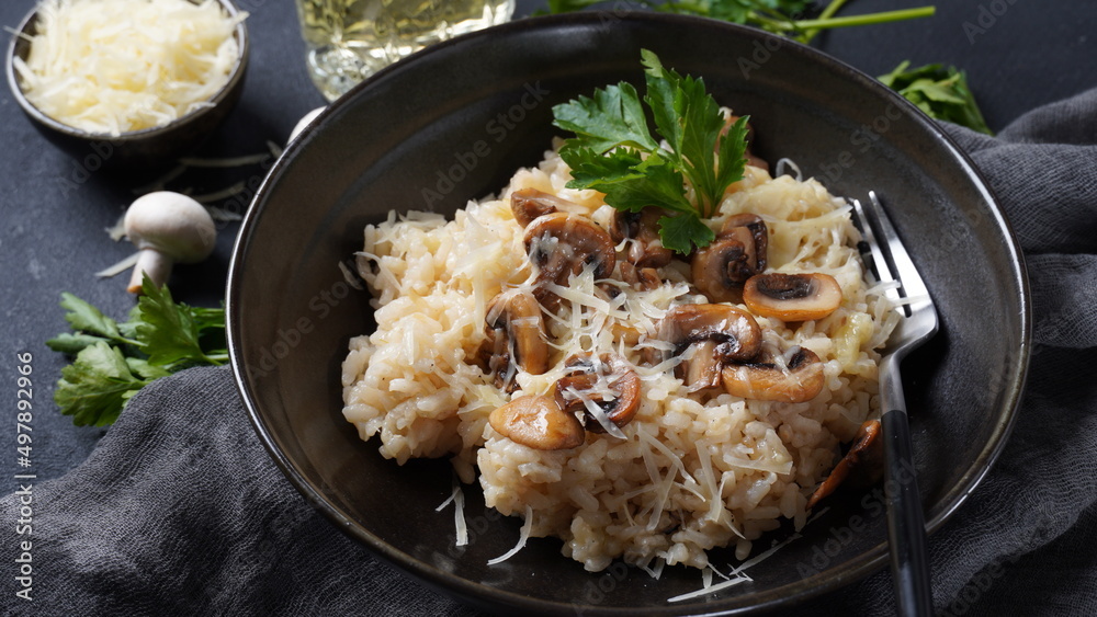 Mushroom risotto garnished with parsley and parmesan. Mushroom risotto garnished with parsley and parmesan.
