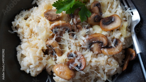 Mushroom risotto garnished with parsley  and parmesan.