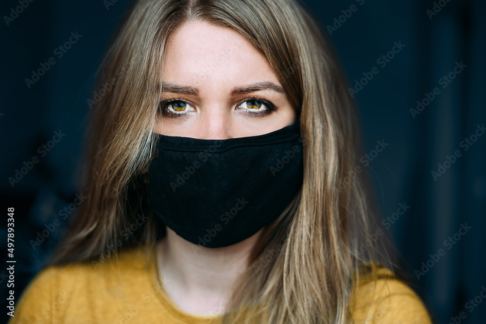 Close-up portrait of a woman in a mask in the colors of the flag of Ukraine. Stop the war Close-up portrait of a woman in a mask in the colors of the flag of Ukraine. Stop the war