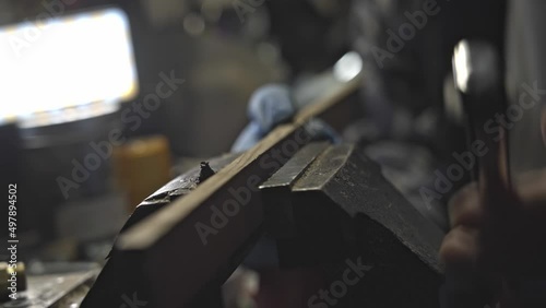 Close up from hand sending wood in bench vise