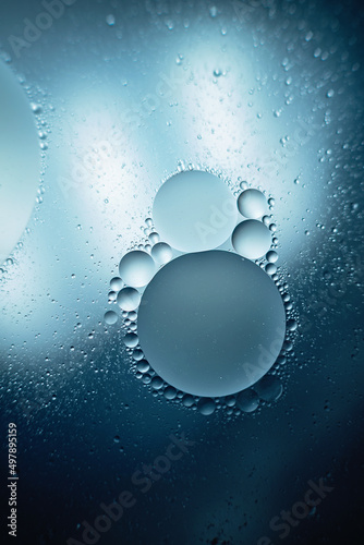 oil with bubbles on dark blue background. Abstract space background. Soft selective focus. macro of oil drops on water surface. copy space. air bubbles in water