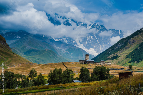 Village Ushguli landscape with massive rocky mountains photo