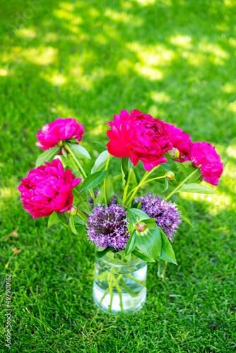 Glass vase with beautiful pink peony flowers
