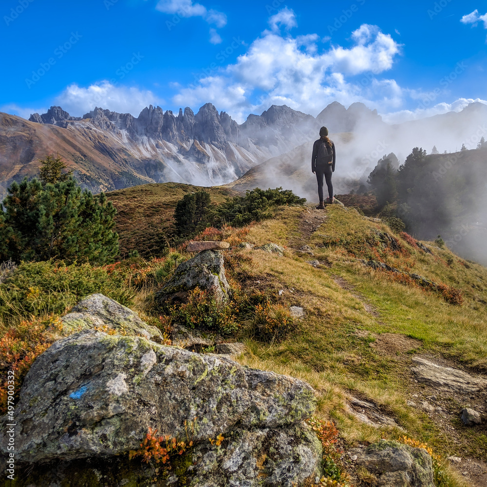 Likeness of the famous painting by German Romantic artist Caspar David Friedrich Wanderer above the Sea of Fog in the Alps near Innsbruck overlooking the Stubai Alps in Austria