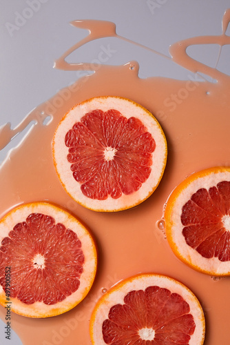 Top view of fresh slice grapefruits juice and gel serum  organic cosmetics