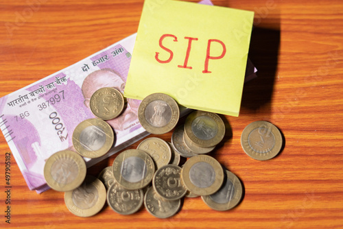 Sip with coin and stack of money table - concept of savings , investment, financial and wealth creation. photo