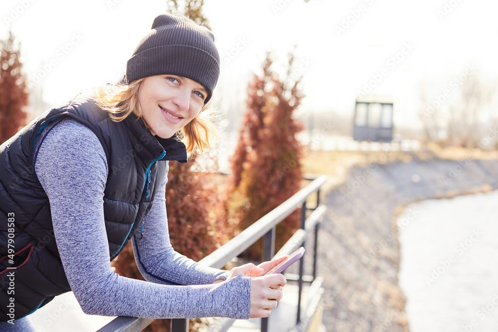 Middle age sportswoman smiling happy using smartphone at the park