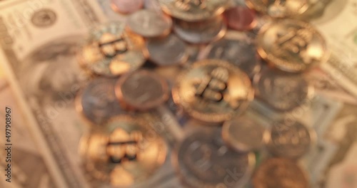 Gold Bitcoin coins on US Dollar banknotes and coins. Trading cryptocurrency concept