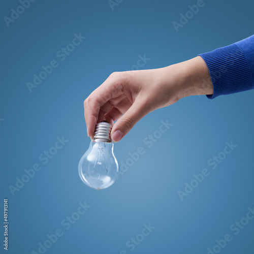 Hand holding an incandescent lighbulb photo