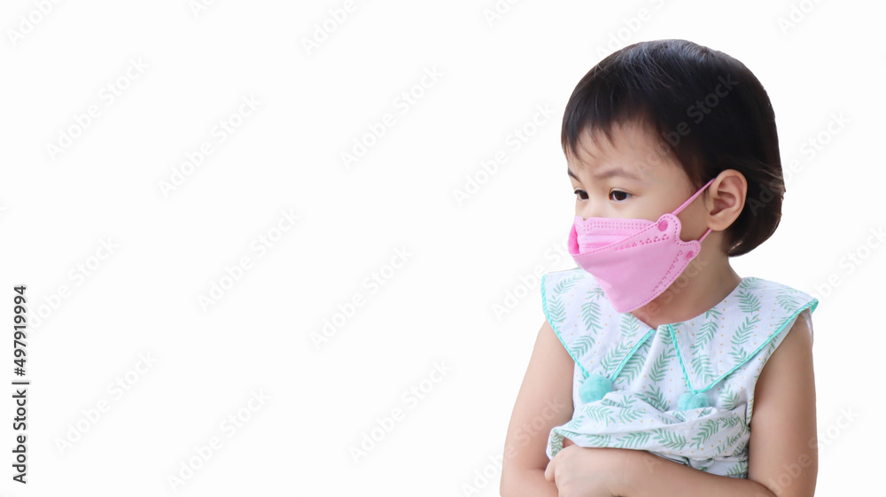 Asian girl little preschooler child wearing 3D face mask looking to the left. Absent minded children. Asian girl little preschooler child wearing 3D face mask looking to the left. Absent minded children.