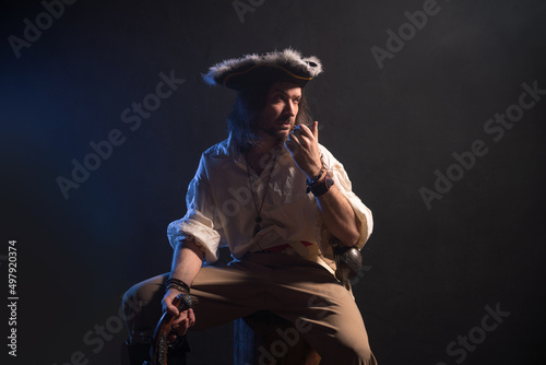 Pirate filibuster sea robber in suit with gun and saber. Concept photo © Fotokvadrat