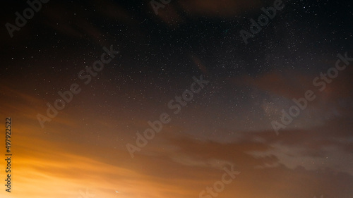 Sunset Evening Bright Sky And Glowing Stars. Natural Background Backdrop In Yellow And Black Colors. Copyspace. space stars starlight Starry sky universe panoramic view panorama.