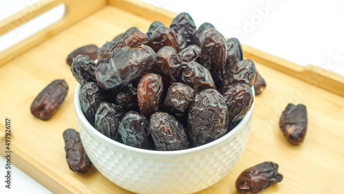 Dates also known as Khajur. Tasty dry dates isolated on white background. Arabic food that muslims eat during Ramadan. Super dietery food.  photo