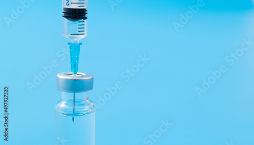 Syringe insertion ampoule on blue background