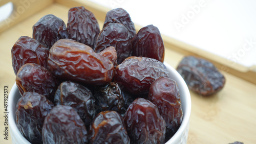 Dates also known as Khajur. Tasty dry dates isolated on white background. Arabic food that muslims eat during Ramadan. Super dietery food.  photo